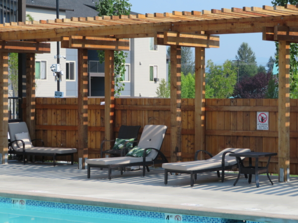 Lounge chairs next to pool at Park77